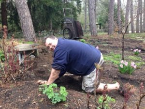Karl Lays Rock Wall in Circle Garden