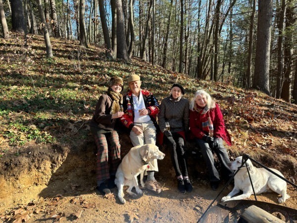Mary, Clint, Edith, Adair, with dogs Honey & Dijon, sit at the recently dug-out fire pit surround seating- to be developed.