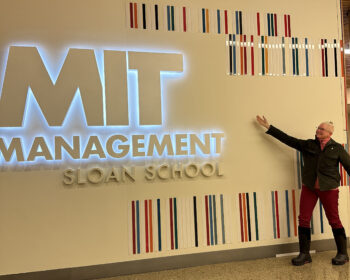 Mary poses at the MIT Management Sloan School Sign