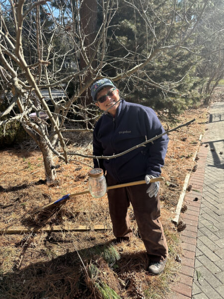 Jean Perreault lightly rakes garden beds