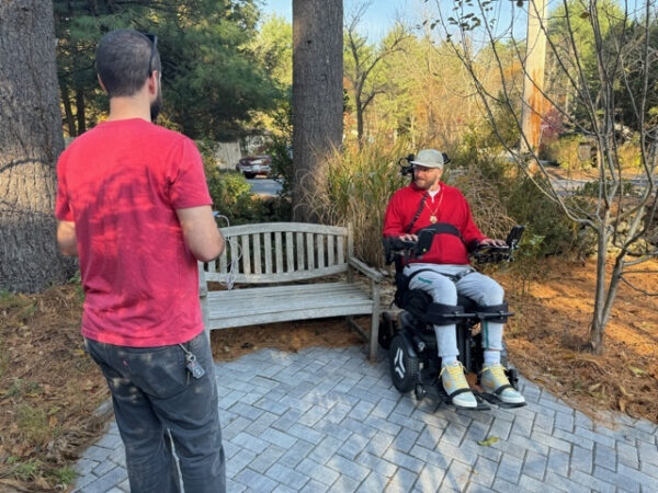 JD illustrates the wheelchair-friendly landscape design allowing him to view the gardens from an off-trail seating area.